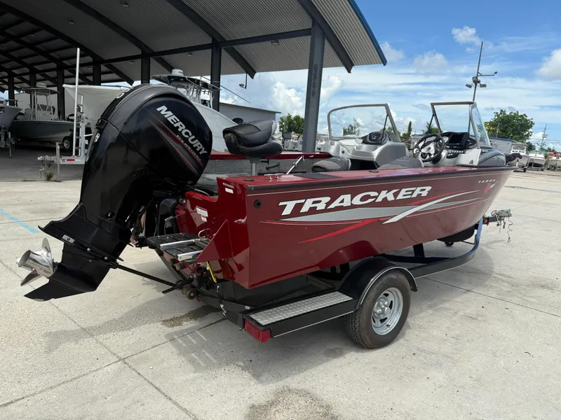 Slide: The Image of 2015 Tracker Targa V18 Combo boat interior with seating and dashboard. - 7