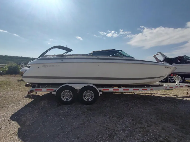 The Image of 2000 Cobalt 262 boat on trailer under clear sky. - 0