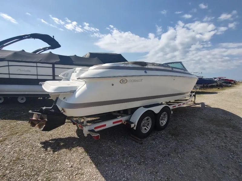 Slide: The Image of 2000 Cobalt 262 boat on trailer under a partly cloudy sky. - 1
