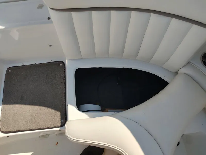 Slide: The Image of Cobalt 262 boat interior, 2000 model, featuring white cushioned seating and storage compartment. - 11