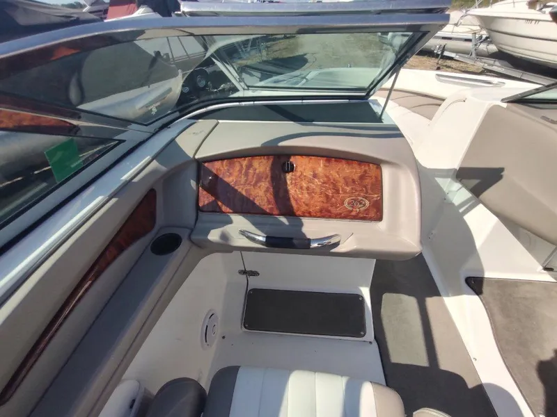 Slide: The Image of Interior of a 2000 Cobalt 262 boat, featuring wood paneling and seating. - 13