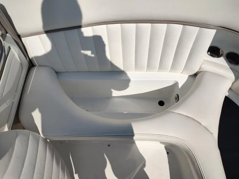 Slide: The Image of Interior of a 2000 Cobalt 262 boat with white seating and cup holders. - 16