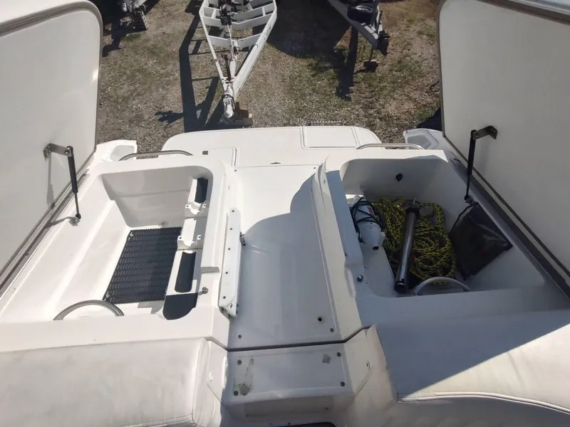 Slide: The Image of Open storage compartments on a 2000 Cobalt 262 boat, showing equipment and ropes. - 23