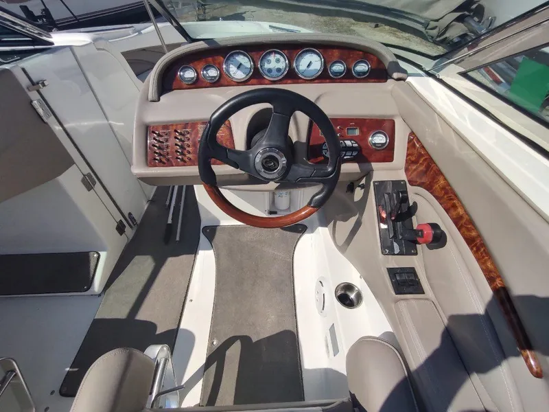Slide: The Image of Interior of a 2000 Cobalt 262 boat showing steering wheel and dashboard controls. - 25