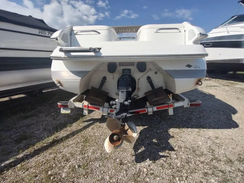 Slide: The Image of Rear view of a 2000 Cobalt 262 boat on a trailer under a clear sky. - 29