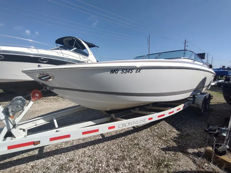 Slide: The Image of 2000 Cobalt 262 boat on trailer, parked outdoors under clear sky. - 30