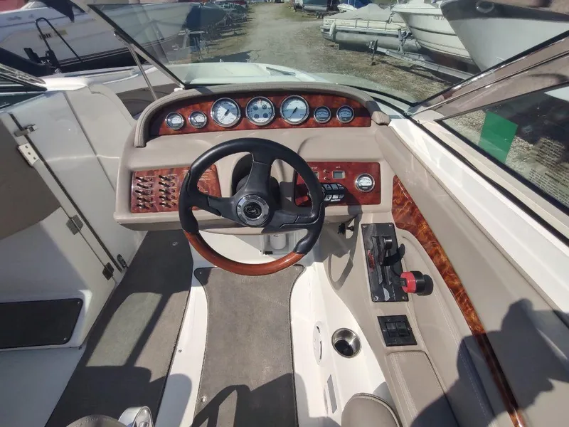 Slide: The Image of Cobalt 262 boat dashboard, 2000 model, featuring wood accents and steering wheel. - 32