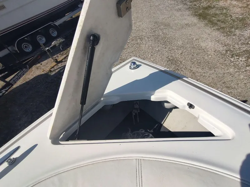 Slide: The Image of Open storage compartment on a 2000 Cobalt 262 boat, showing anchor and chain inside. - 7
