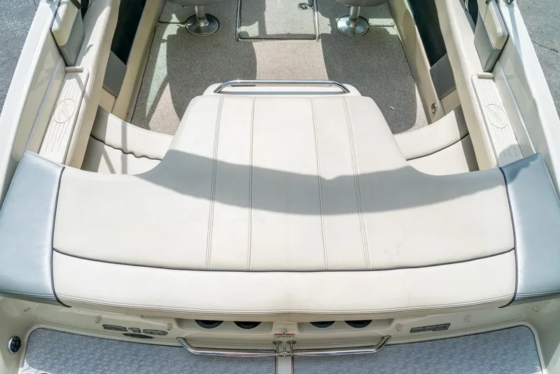 Slide: The Image of 2009 Sea Ray 210 Select boat interior with beige seating and carpeted flooring. - 11