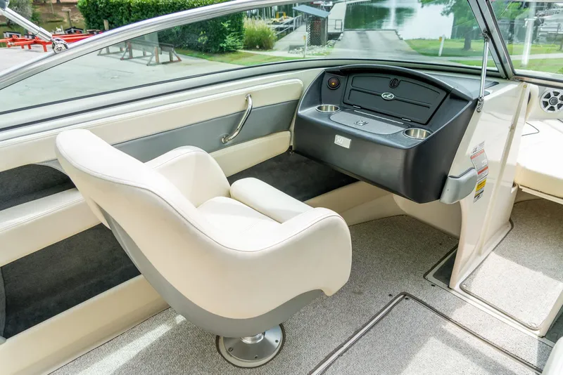Slide: The Image of Interior of 2009 Sea Ray 210 Select boat, featuring a sleek helm and comfortable seating. - 14