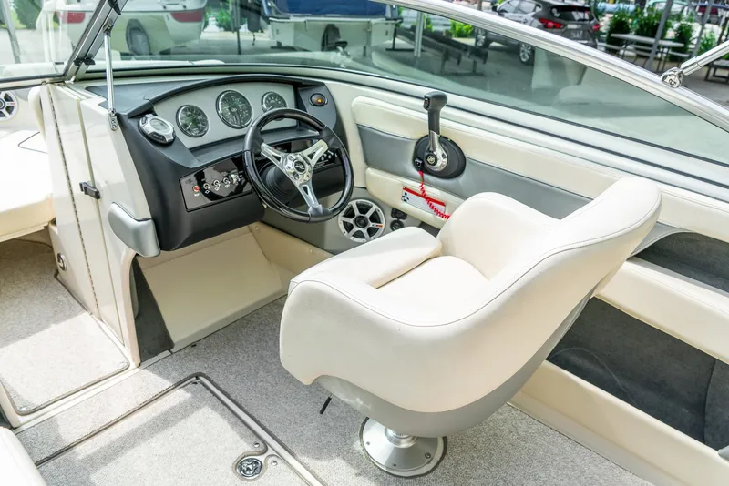 Slide: The Image of 2009 Sea Ray 210 Select boat interior with steering wheel and dashboard controls. - 15