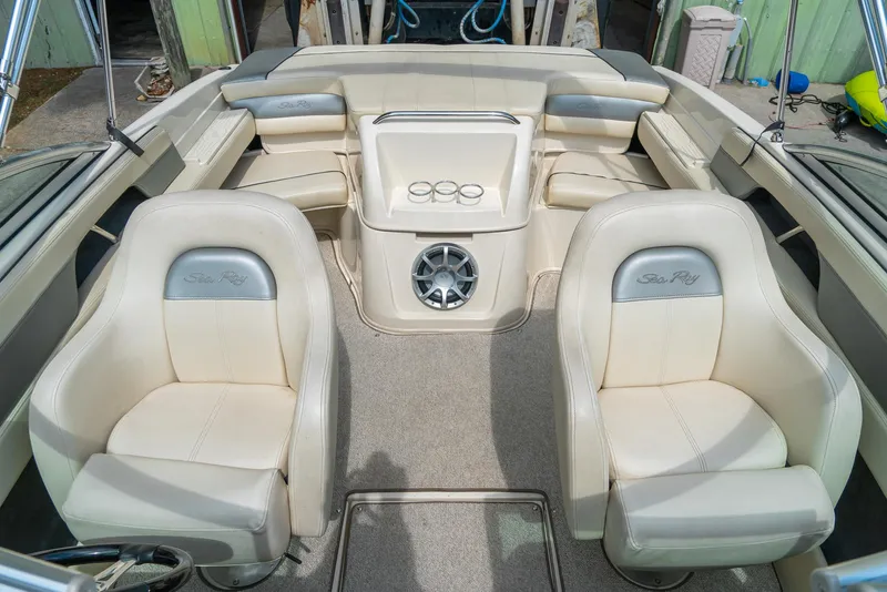 Slide: The Image of 2009 Sea Ray 210 Select boat interior with beige seating and speaker system. - 19