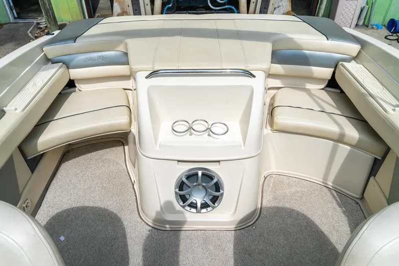 Slide: The Image of 2009 Sea Ray 210 Select boat interior with beige seating and speaker system. - 20