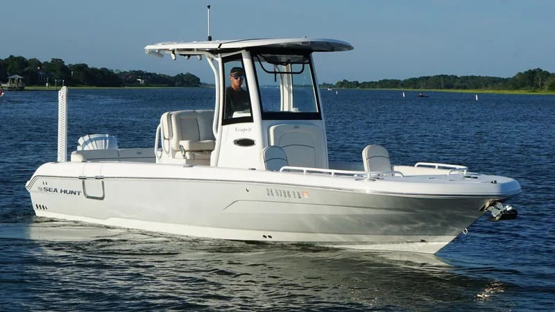 Slide: The Image of 2023 Sea Hunt Escape 25 boat cruising on a calm lake. - 4