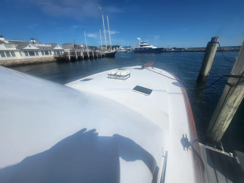 Slide: The Image of 1989 Ocean Yachts 48 docked at a marina under clear blue skies. - 11