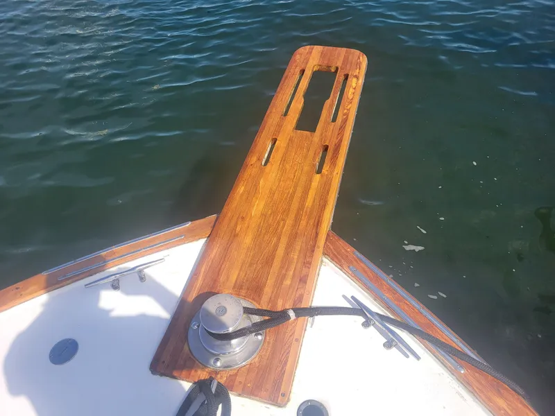 Slide: The Image of Bow of 1989 Ocean Yachts 48 with wooden pulpit over water. - 14