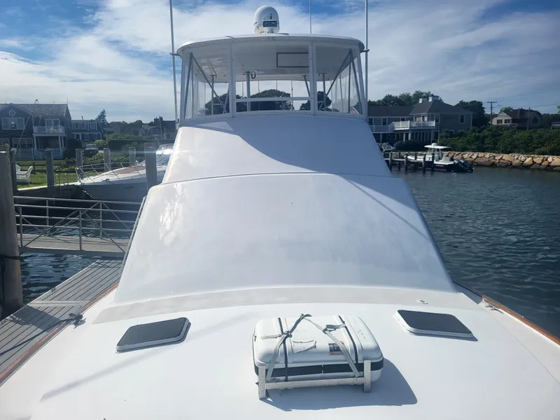 Slide: The Image of 1989 Ocean Yachts 48 docked at a marina, showcasing its sleek white design. - 16