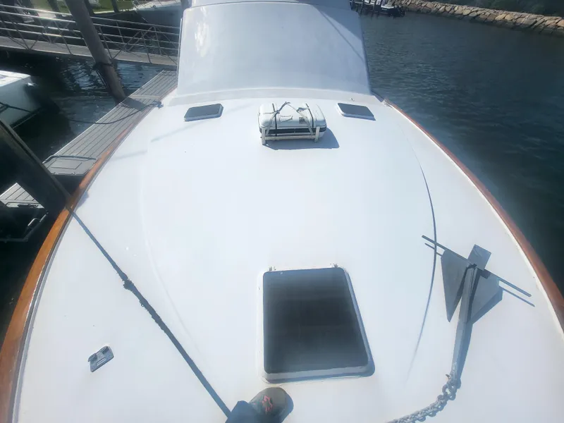 Slide: The Image of 1989 Ocean Yachts 48 boat deck with anchor and hatch, docked at marina. - 17