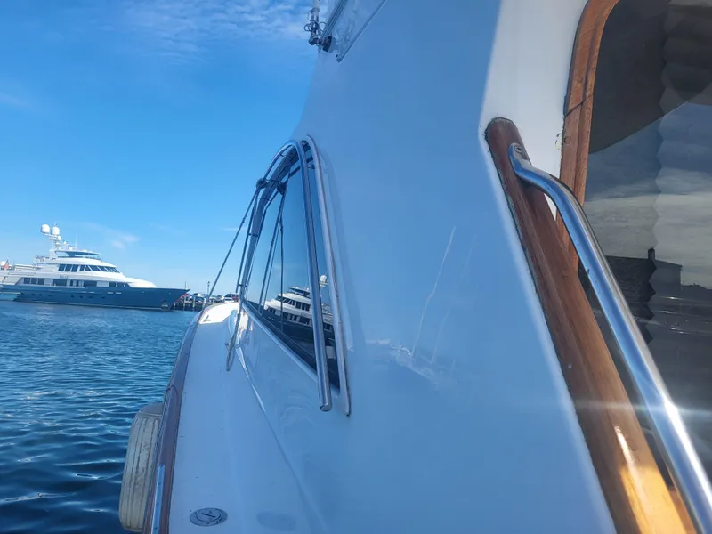 Slide: The Image of 1989 Ocean Yachts 48 side view with blue sky and water background. - 20