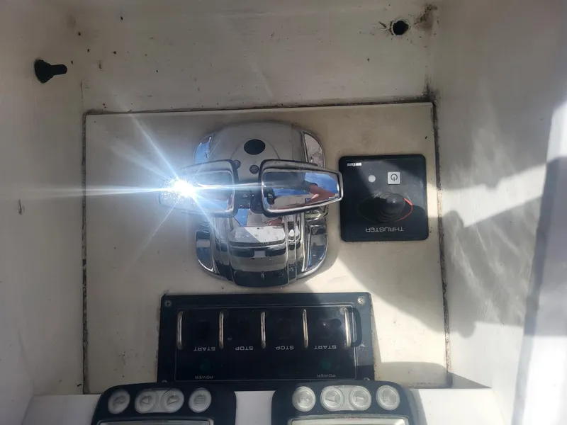 Slide: The Image of Control panel of a 1989 Ocean Yachts 48, featuring chrome and electronic switches. - 25