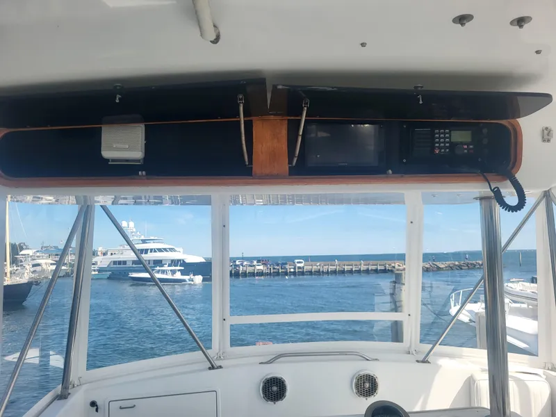 Slide: The Image of Interior view of 1989 Ocean Yachts 48, featuring navigation equipment and ocean backdrop. - 26