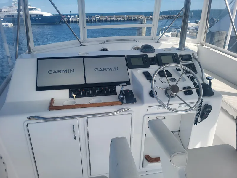 Slide: The Image of Cockpit of 1989 Ocean Yachts 48 with Garmin navigation, steering wheel, and controls. - 27