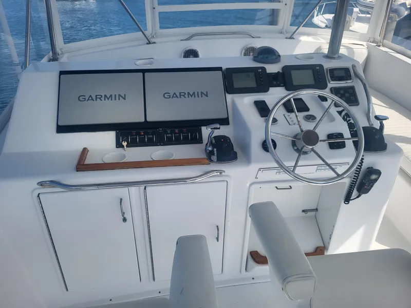 Slide: The Image of Cockpit of 1989 Ocean Yachts 48 with Garmin navigation displays and steering wheel. - 28