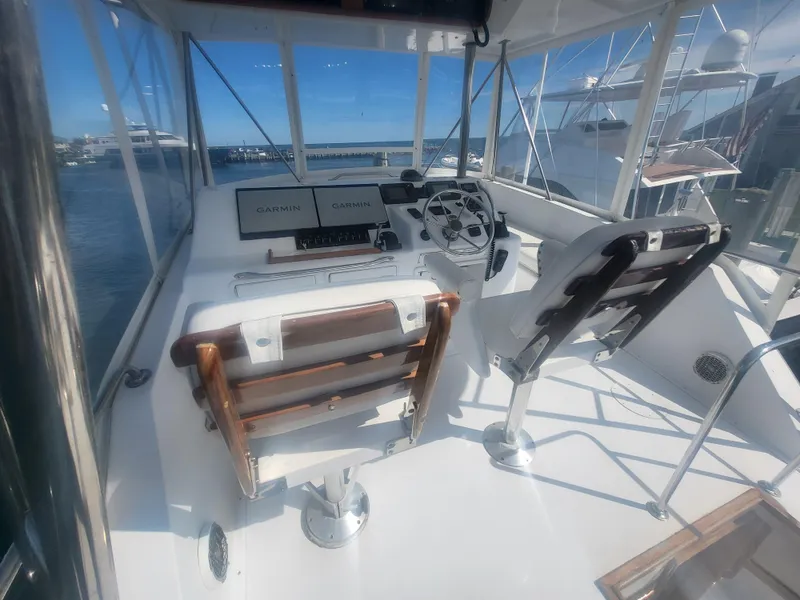 Slide: The Image of 1989 Ocean Yachts 48 cockpit with Garmin navigation, featuring dual seats and steering wheel. - 30