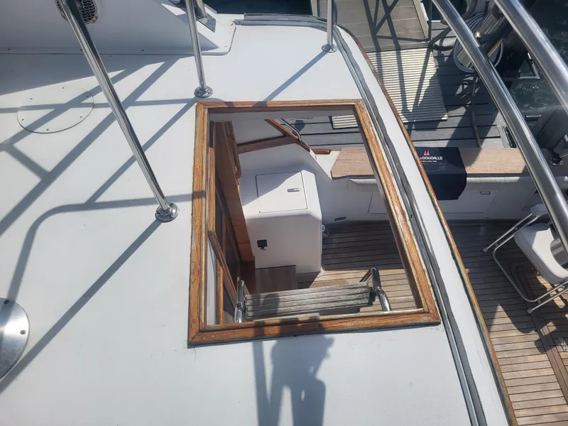 Slide: The Image of 1989 Ocean Yachts 48 deck view with open hatch and wooden trim. - 32