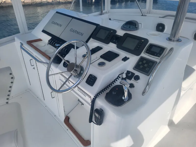 Slide: The Image of 1989 Ocean Yachts 48 helm with Garmin navigation systems and steering wheel. - 35