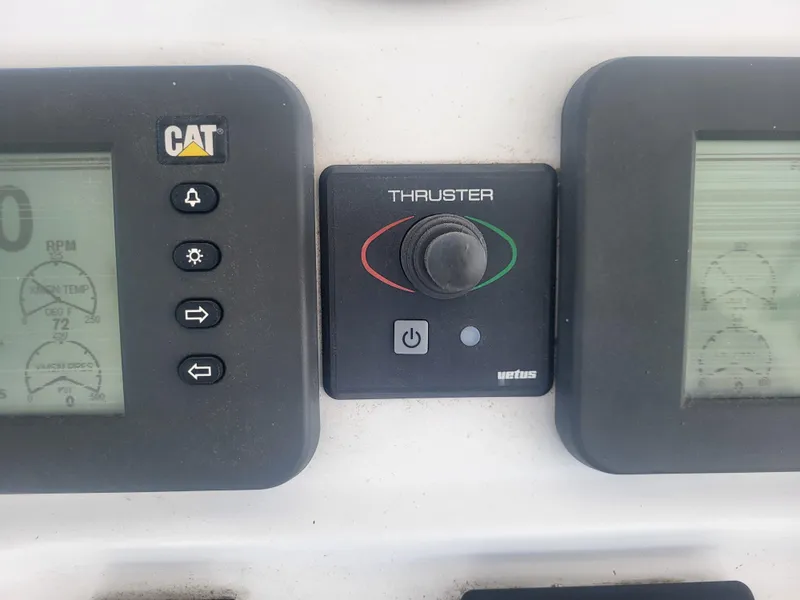 Slide: The Image of Control panel of a 1989 Ocean Yachts 48, featuring CAT and Vetus thruster controls. - 38