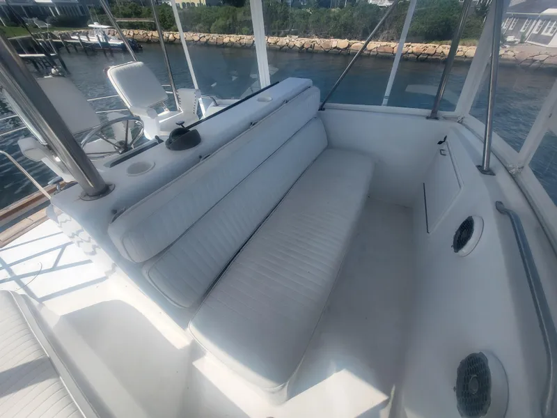 Slide: The Image of 1989 Ocean Yachts 48 interior with white seating, helm, and waterfront view. - 42