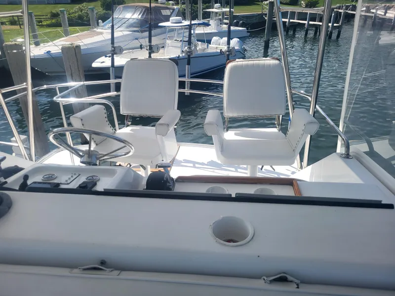 Slide: The Image of Cockpit of 1989 Ocean Yachts 48 with white captain chairs and steering wheel. - 45