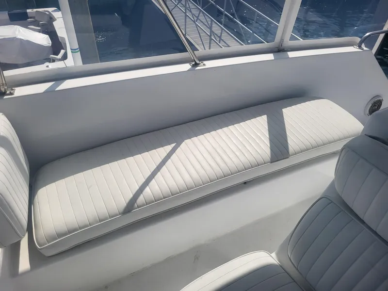 Slide: The Image of White seating area on a 1989 Ocean Yachts 48 boat, with sunlight and shadows. - 46