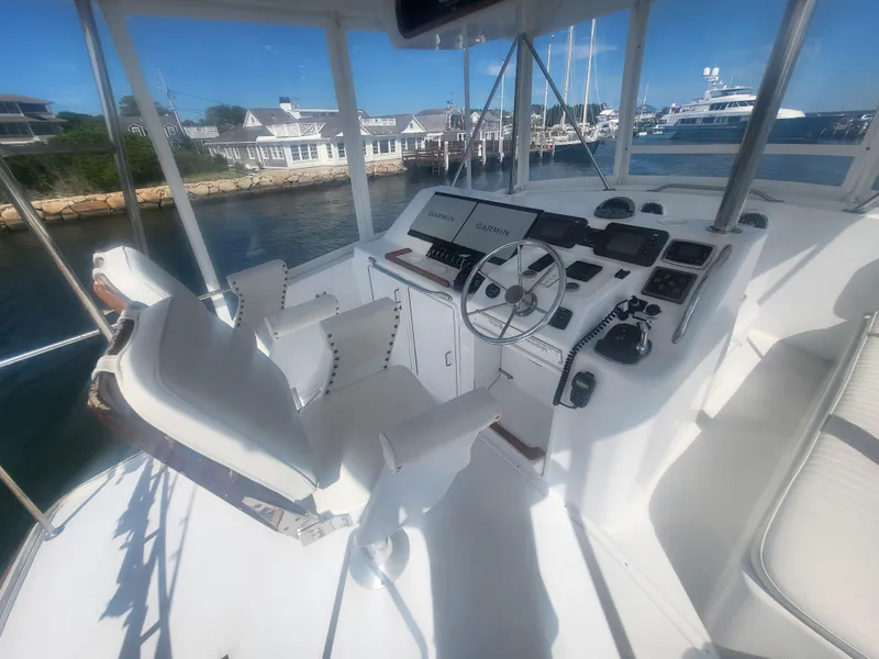 Slide: The Image of Cockpit of 1989 Ocean Yachts 48 with steering wheel and navigation equipment. - 47