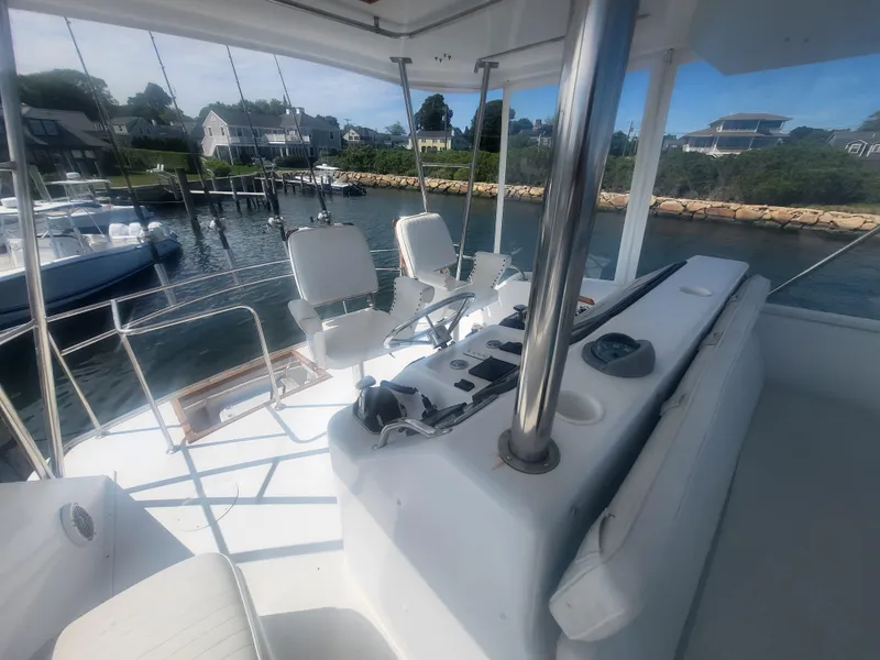 Slide: The Image of 1989 Ocean Yachts 48 boat interior with helm, chairs, and waterfront view. - 49