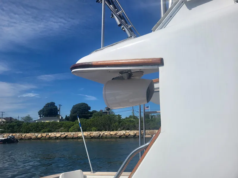 Slide: The Image of 1989 Ocean Yachts 48 boat detail with clear sky and shoreline background. - 9