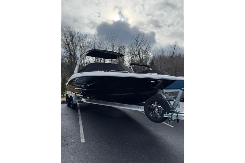 Slide: The Image of 2026 Chaparral 23 SSi boat on trailer, parked outdoors under cloudy sky. - 18