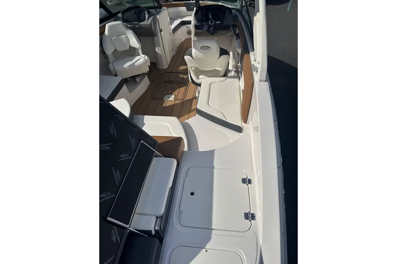 Slide: The Image of 2026 Chaparral 23 SSi boat interior with white seating and wood accents. - 24