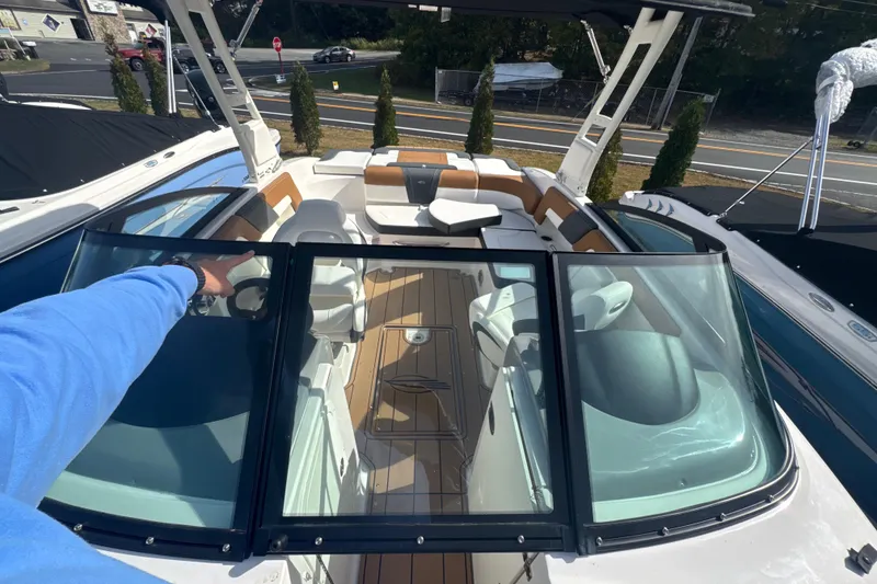 Slide: The Image of 2026 Chaparral 23 SSi boat interior with seating and steering wheel, viewed from above. - 26