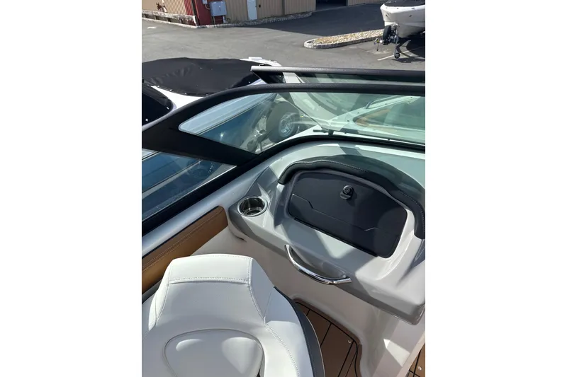 Slide: The Image of 2026 Chaparral 23 SSi boat interior with white seating and dashboard view. - 28
