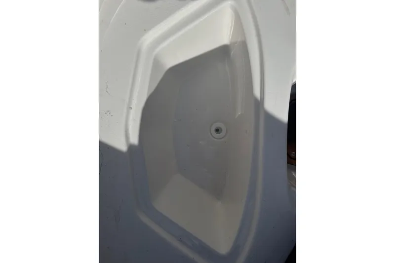 Slide: The Image of White interior compartment of 2026 Chaparral 23 SSi boat, featuring a clean, sleek design. - 30