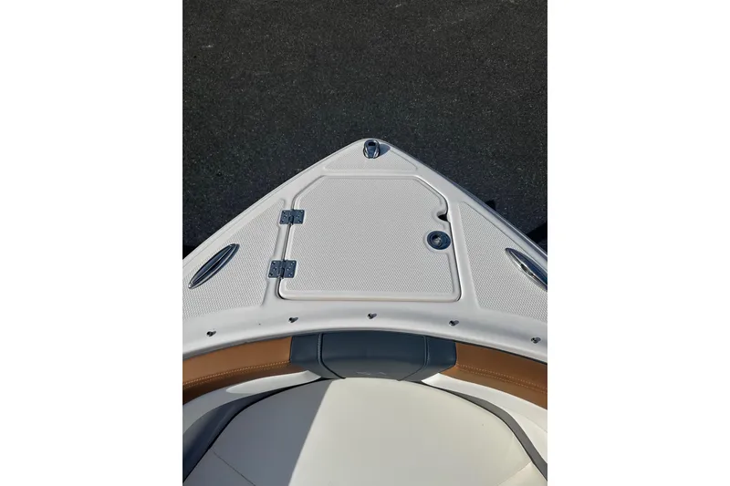 Slide: The Image of Bow view of 2026 Chaparral 23 SSi boat with sleek design and storage hatch. - 31