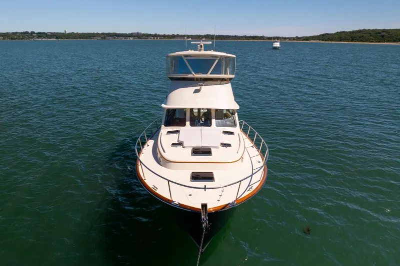 Slide: The Image of 2014 Hinckley Talaria 48 Flybridge yacht on calm water, front view. - 6