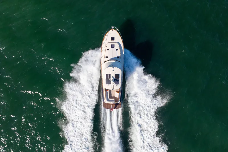 Slide: The Image of Aerial view of 2014 Hinckley Talaria 48 Flybridge yacht cruising on open water. - 9