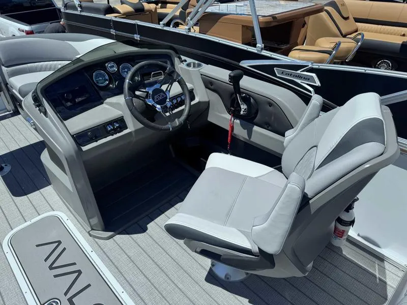 Slide: The Image of 2025 Avalon 2385 25 LSZ QL boat cockpit with steering wheel and captain's chair. - 7