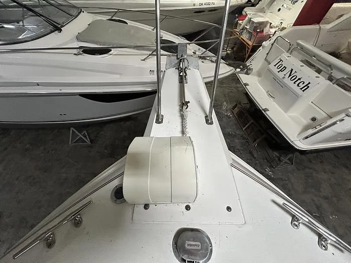 Slide: The Image of 1990 Carver 3257 MONTEGO boat docked indoors alongside other vessels. - 12