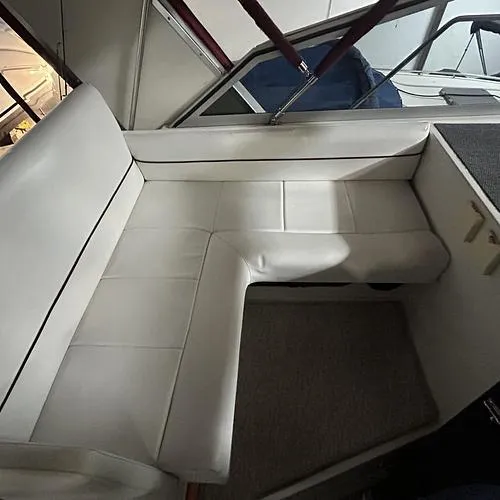Slide: The Image of Interior seating of 1990 Carver 3257 MONTEGO boat, featuring white upholstery. - 19