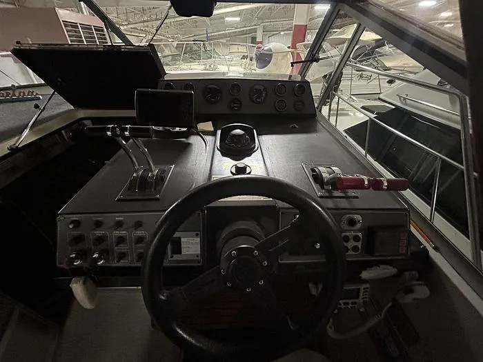 Slide: The Image of 1990 Carver 3257 MONTEGO boat cockpit with steering wheel and control panel. - 20