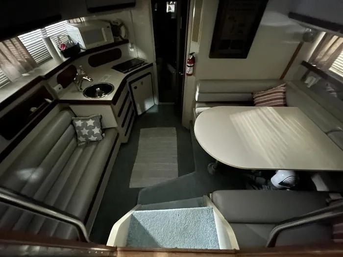 Slide: The Image of Interior of a 1990 Carver 3257 MONTEGO boat with kitchen and dining area. - 21